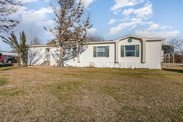 view of front of house with a detached carport and a front yard