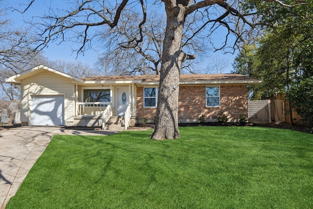 ranch-style home with brick siding, an attached garage, fence, driveway, and a front lawn