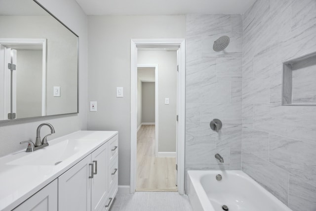 full bathroom with baseboards, tub / shower combination, and vanity