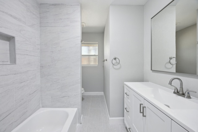 full bathroom featuring tub / shower combination, vanity, toilet, and baseboards