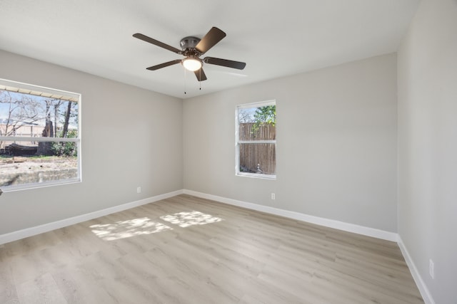 empty room featuring ceiling fan, wood finished floors, and baseboards