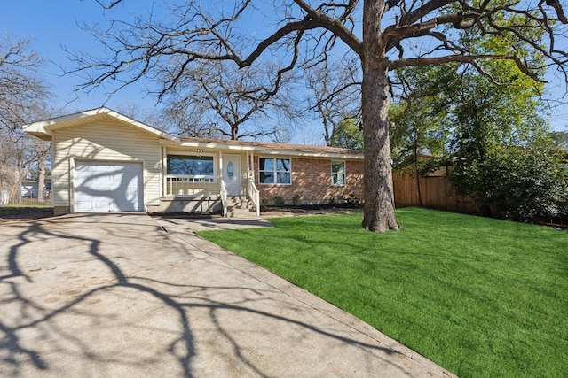 ranch-style home featuring an attached garage, brick siding, fence, concrete driveway, and a front lawn