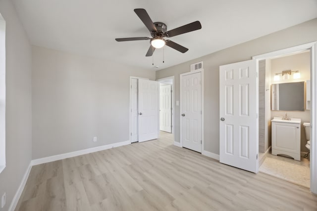 unfurnished bedroom with light wood-style flooring, ensuite bath, visible vents, and baseboards