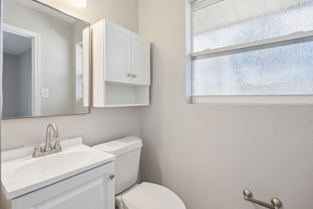 bathroom featuring toilet and vanity