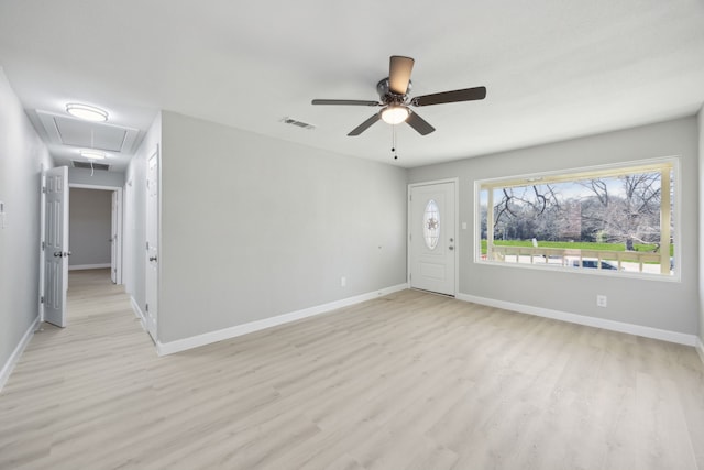 foyer featuring light wood finished floors, visible vents, and baseboards