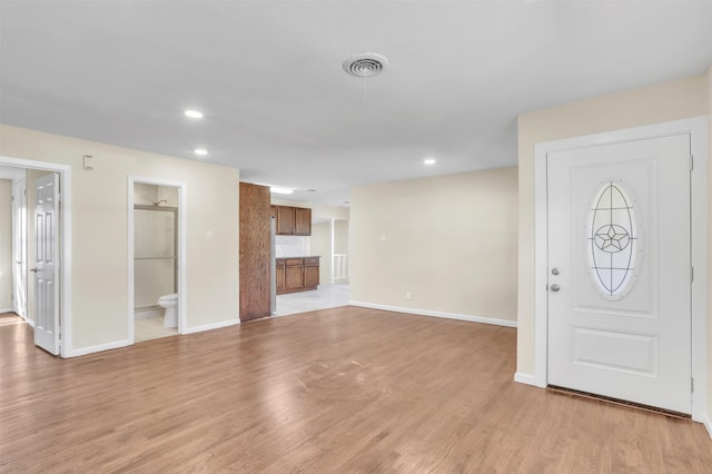 foyer entrance featuring light wood-style flooring, visible vents, baseboards, and recessed lighting