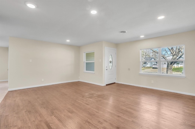 interior space featuring light wood-style floors, baseboards, and recessed lighting