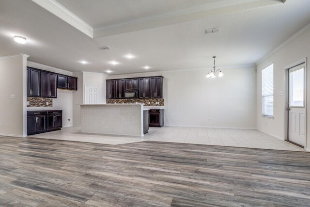 2305 Simmental Rd, Fort Worth, TX 76131 - kitchen featuring crown molding, black microwave, decorative backsplash, a chandelier, and open floor plan