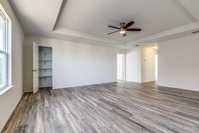 2305 Simmental Rd, Fort Worth, TX 76131 - empty room featuring a raised ceiling, ceiling fan, wood finished floors, crown molding, and baseboards