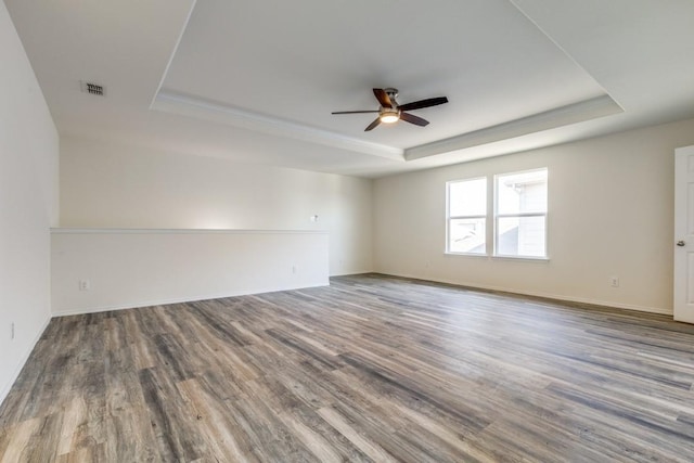 2305 Simmental Rd, Fort Worth, TX 76131 - empty room with a tray ceiling, a ceiling fan, wood finished floors, and baseboards