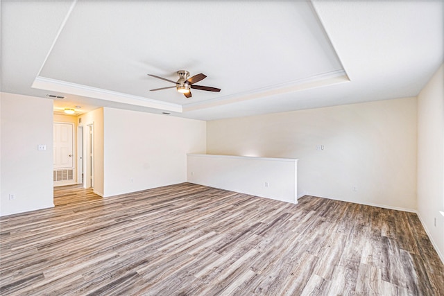 2305 Simmental Rd, Fort Worth, TX 76131 - empty room with a tray ceiling, ceiling fan, wood finished floors, and ornamental molding