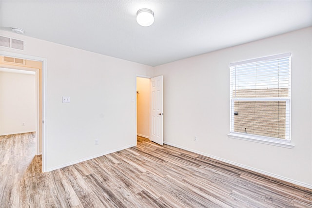 2305 Simmental Rd, Fort Worth, TX 76131 - spare room featuring wood finished floors, baseboards, and a smoke detector