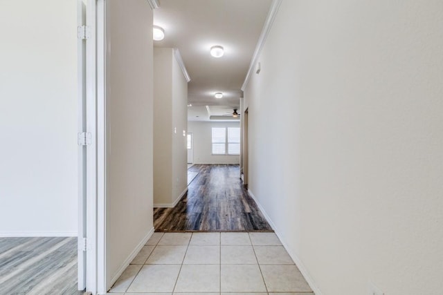 hallway with light tile patterned flooring and baseboards