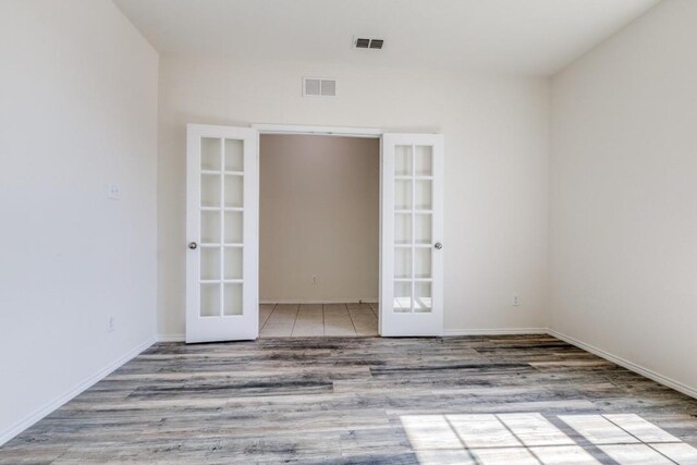 2305 Simmental Rd, Fort Worth, TX 76131 - spare room with french doors, wood finished floors, and baseboards
