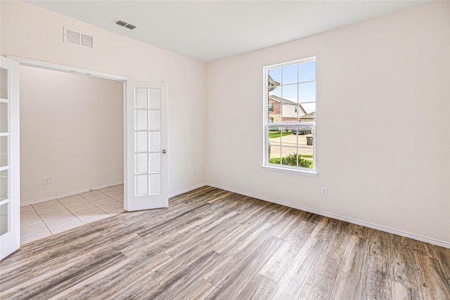 2305 Simmental Rd, Fort Worth, TX 76131 - spare room with wood finished floors, french doors, and baseboards
