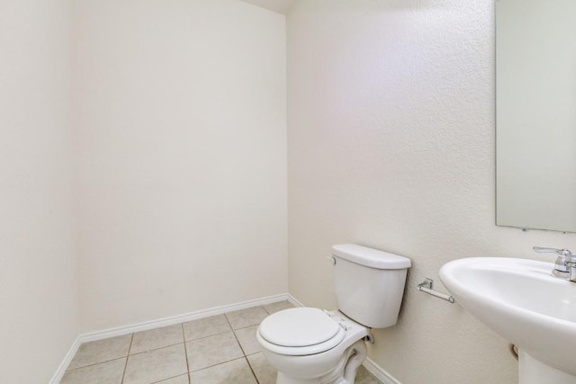 2305 Simmental Rd, Fort Worth, TX 76131 - bathroom featuring toilet, tile patterned floors, baseboards, and a sink