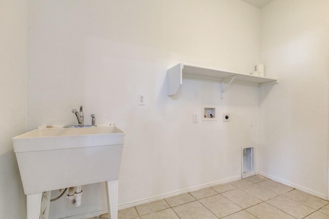 2305 Simmental Rd, Fort Worth, TX 76131 - laundry room featuring washer hookup, hookup for an electric dryer, light tile patterned floors, and baseboards
