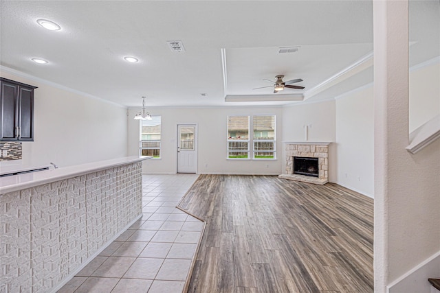 2305 Simmental Rd, Fort Worth, TX 76131 - unfurnished living room with crown molding, a ceiling fan, light wood finished floors, a fireplace, and recessed lighting