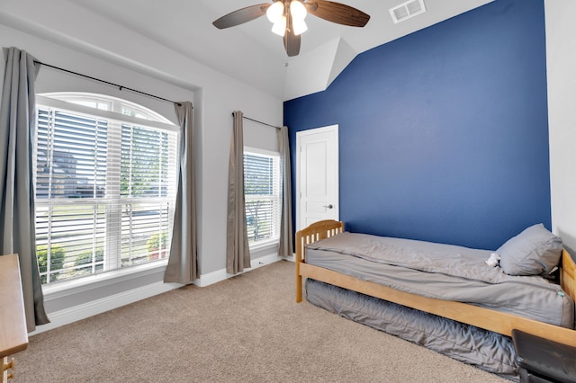 carpeted bedroom with vaulted ceiling, ceiling fan, visible vents, and baseboards