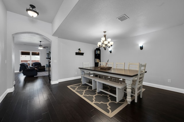 dining area featuring arched walkways, visible vents, wood finished floors, baseboards, and ceiling fan with notable chandelier