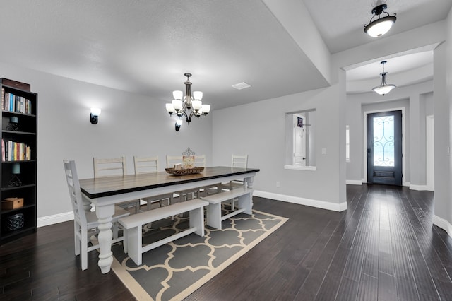 dining space featuring an inviting chandelier, visible vents, baseboards, and dark wood-style flooring