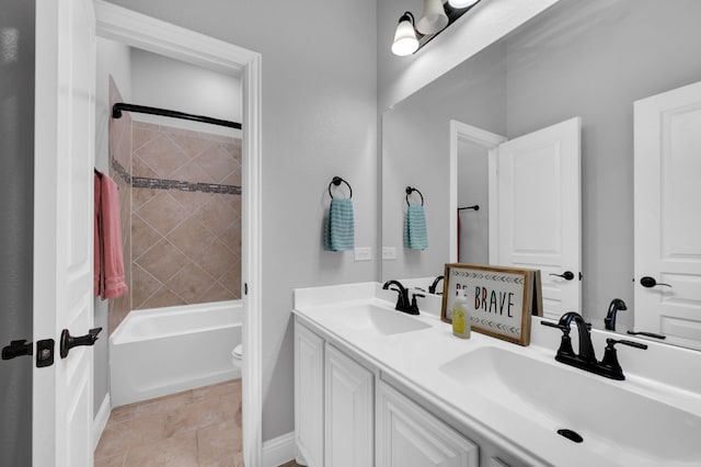 bathroom with double vanity, toilet, shower / washtub combination, and a sink