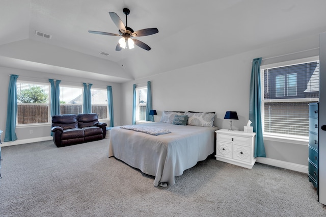 carpeted bedroom with visible vents, vaulted ceiling, baseboards, and ceiling fan