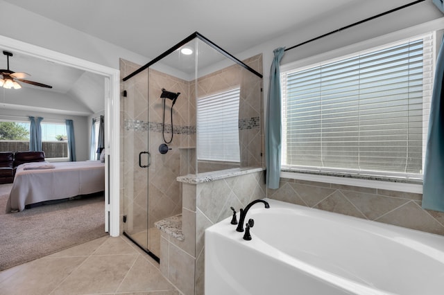 ensuite bathroom with a ceiling fan, a bath, tile patterned floors, a stall shower, and ensuite bath