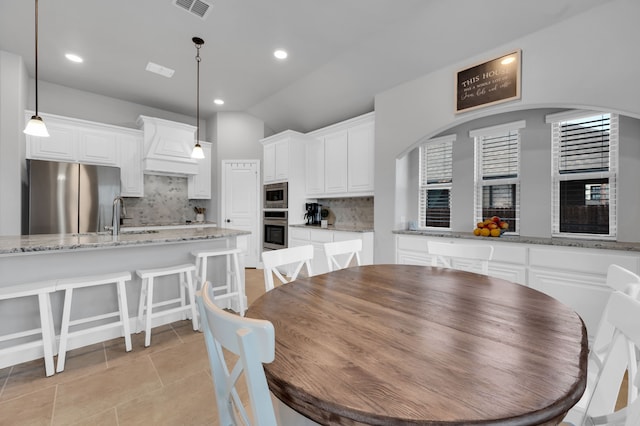 dining area with vaulted ceiling, light tile patterned flooring, visible vents, and recessed lighting