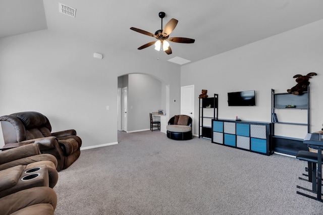 living room with arched walkways, ceiling fan, carpet floors, visible vents, and baseboards