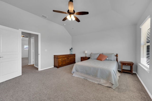 carpeted bedroom with ceiling fan, baseboards, visible vents, and vaulted ceiling