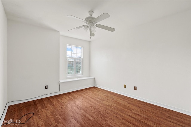 spare room featuring ceiling fan, wood finished floors, and baseboards