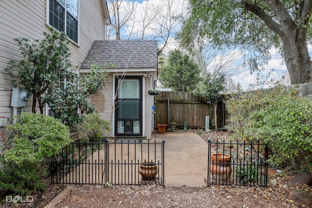 exterior space featuring roof with shingles and fence