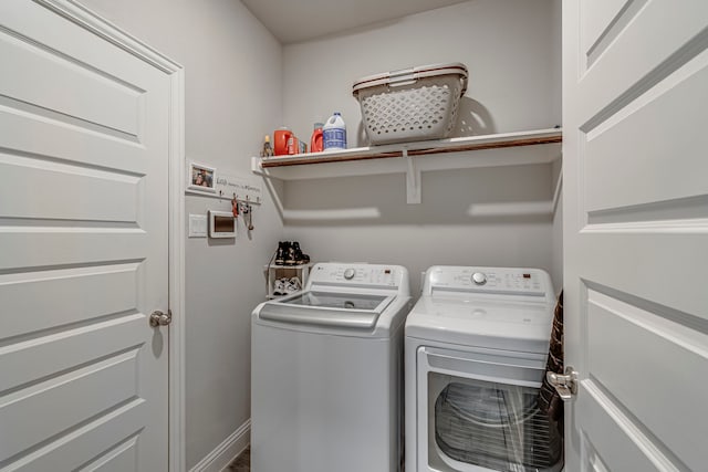 laundry area featuring laundry area, washer and clothes dryer, and baseboards