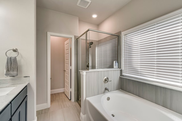 full bathroom with a bath, vanity, a shower stall, and visible vents