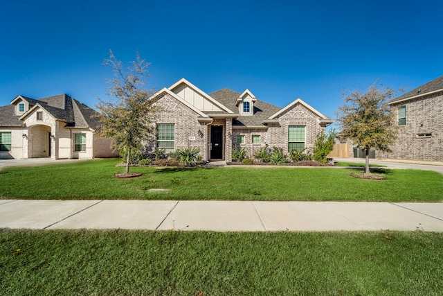 view of front of home with board and batten siding, brick siding, and a front lawn