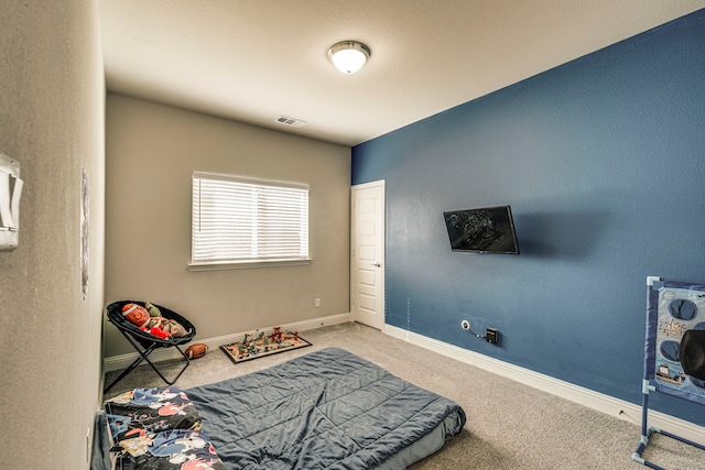 bedroom with carpet, visible vents, and baseboards