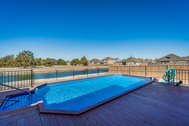 view of swimming pool with a wooden deck, a fenced backyard, and a fenced in pool