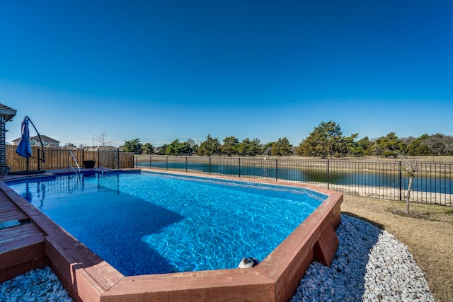 view of pool with a fenced in pool, a fenced backyard, and a water view