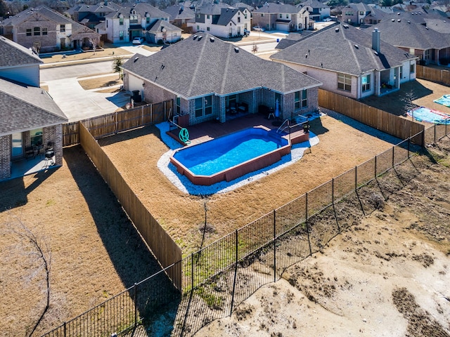 view of pool featuring a patio, a fenced backyard, and a residential view