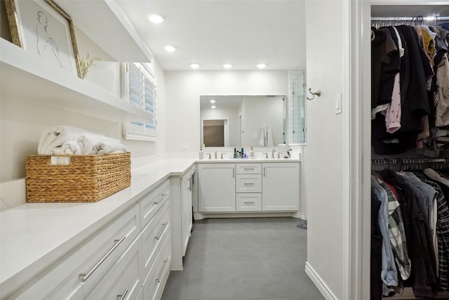 full bath with recessed lighting, a tile shower, vanity, and a spacious closet