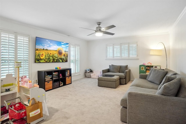 living area with ceiling fan, ornamental molding, and carpet