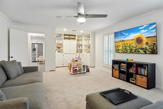 living room featuring a ceiling fan, baseboards, ornamental molding, and carpet flooring