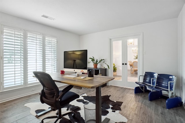 office featuring baseboards, visible vents, wood finished floors, and french doors