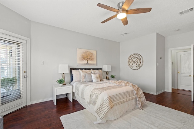 bedroom featuring access to outside, visible vents, baseboards, and hardwood / wood-style flooring