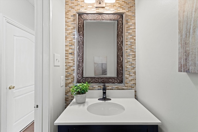 bathroom with tasteful backsplash and vanity