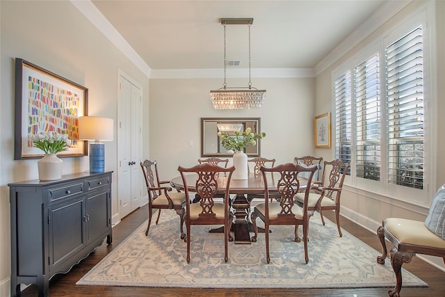 dining space with baseboards, dark wood-style flooring, and crown molding