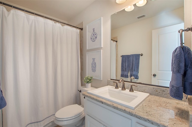 bathroom featuring toilet, visible vents, and vanity