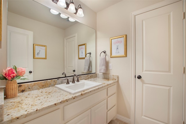 bathroom featuring vanity and a notable chandelier