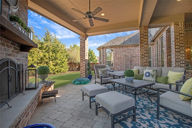 view of patio / terrace with an outdoor hangout area, fence, and a ceiling fan